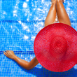 woman in hat at pool